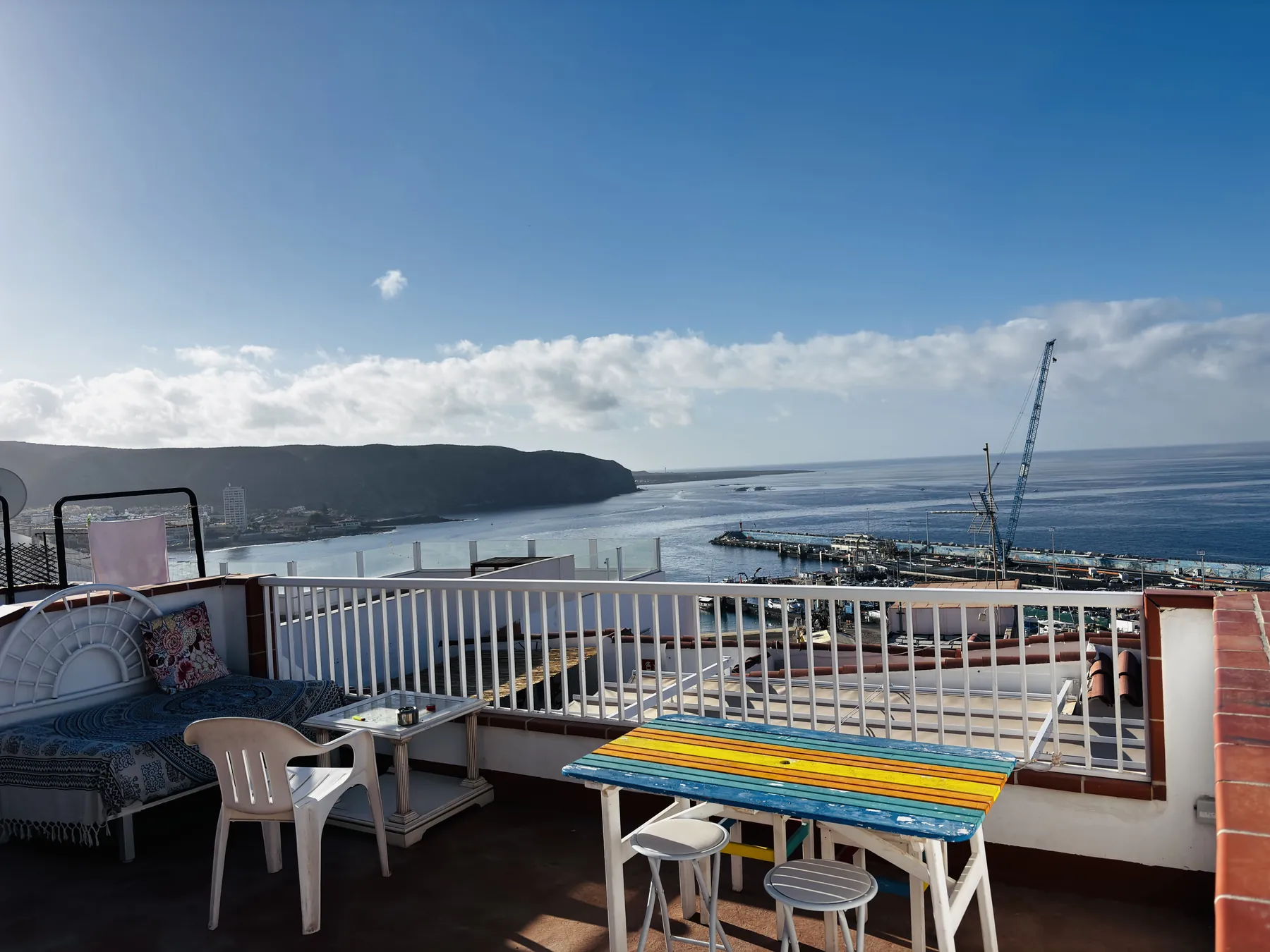 Terraza de arriba con mesas al sol y vistas al mar